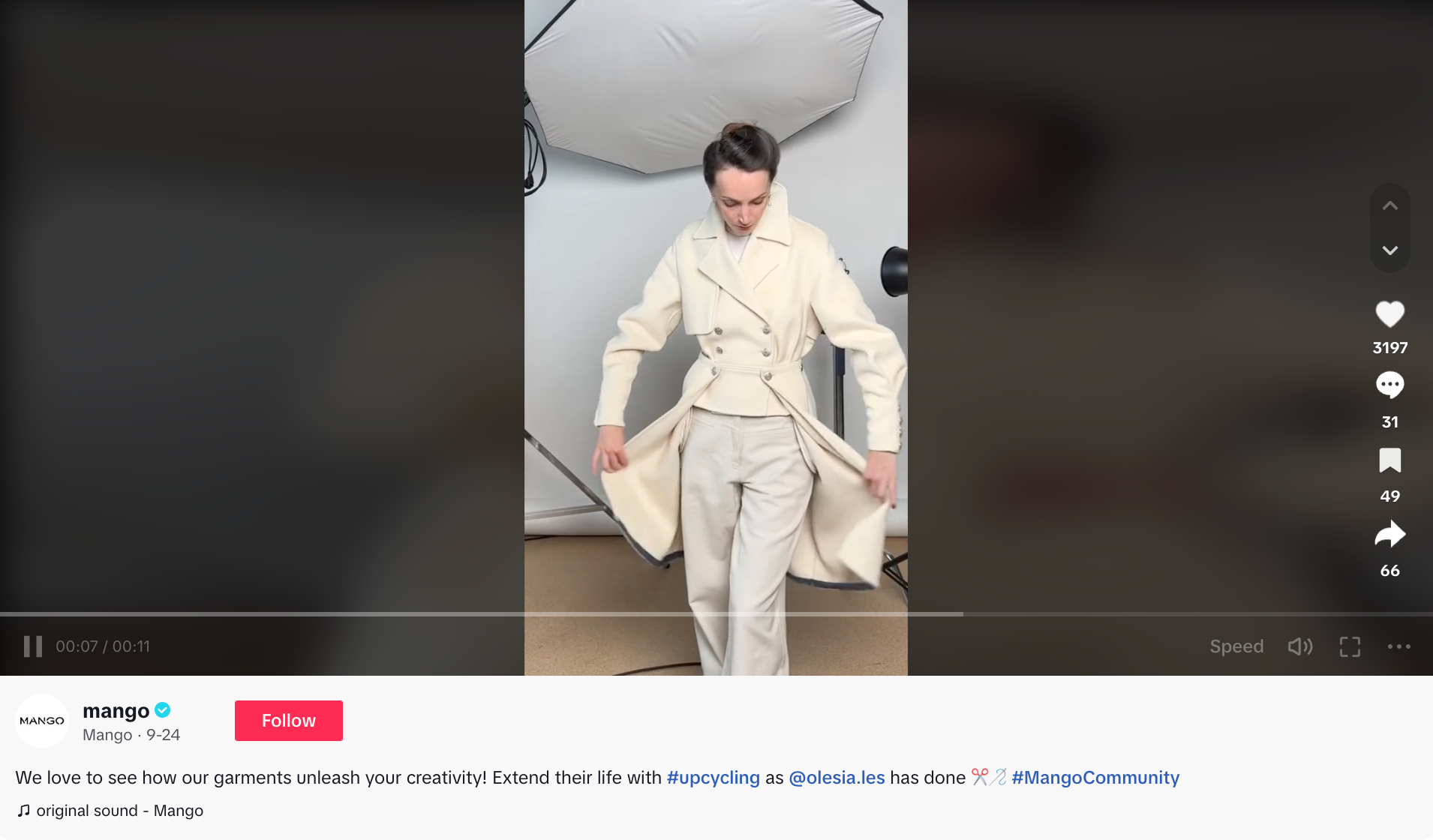 screenshot from mango's tiktok with a brunette woman wearing a white coat